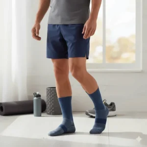 A person standing comfortably while wearing the best socks for plantar fasciitis during a walk or light activity.